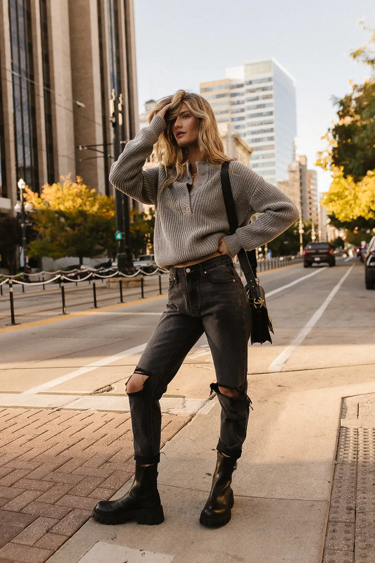 Long sleeves sweater in grey paired with a black distressed denim 