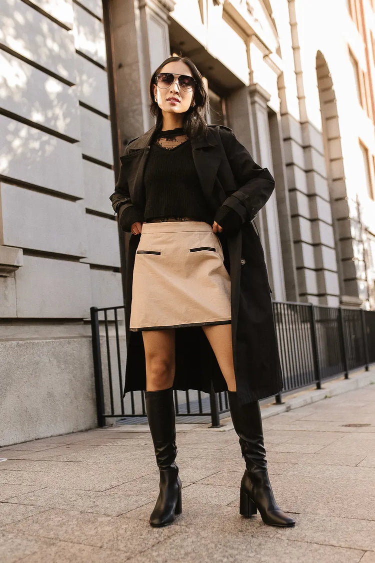 Mini skirt in khaki paired with a trench coat in black  