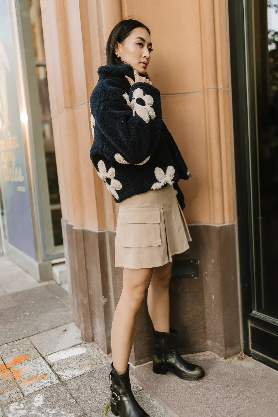 Mini skirt paired with a floral teddy jacket 