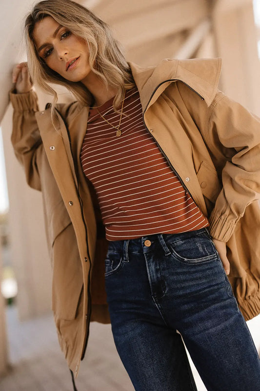 Striped top paired with a camel coat 
