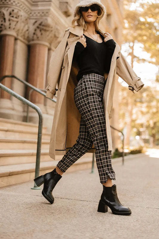 Plaid pants paired with a trench coat