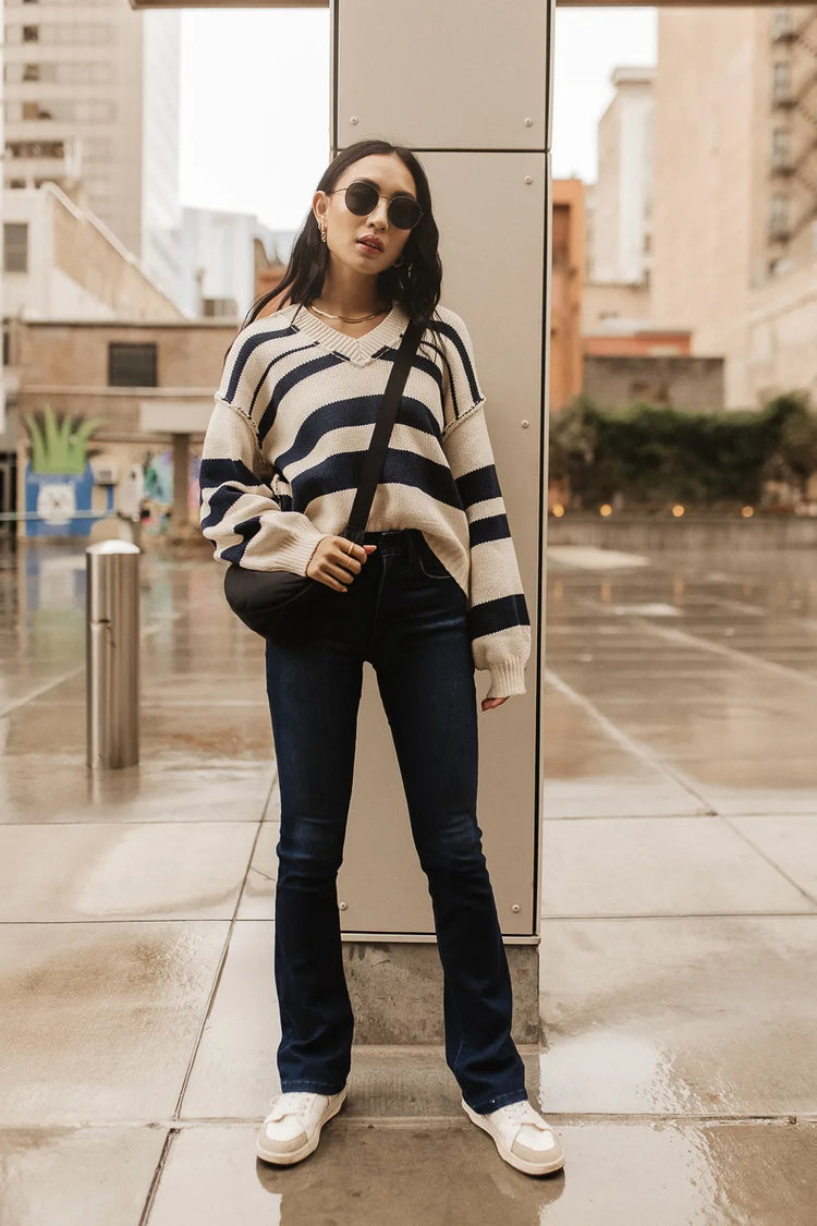 Striped sweater paired with a crossbody bag 