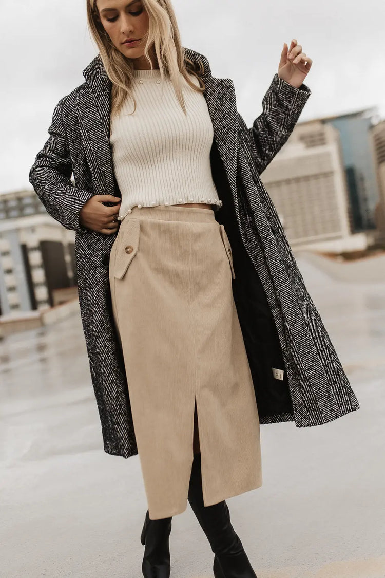 Corduroy skirt paired with a long coat 