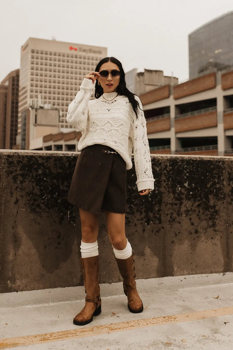 Mini wool skirt paired with a sweater inn ivory 