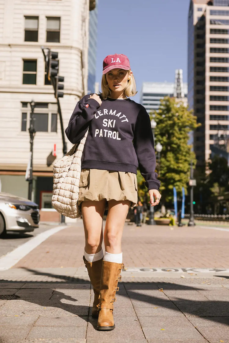 Cargo skirt paired with a navy sweatshirt 
