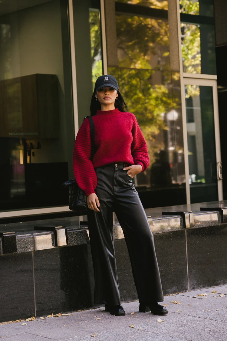 Sweater in red paired with a leather pants 