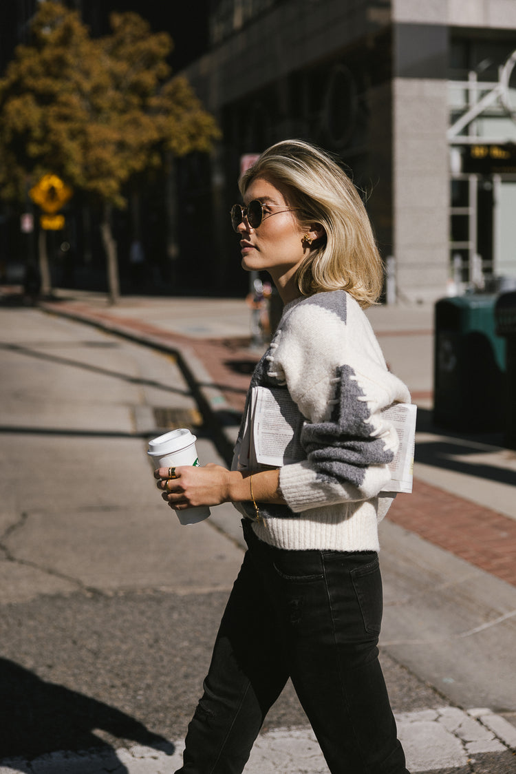 cream and grey stitched sweater