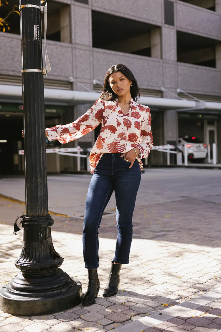 Floral blouse paired with a dark denim 