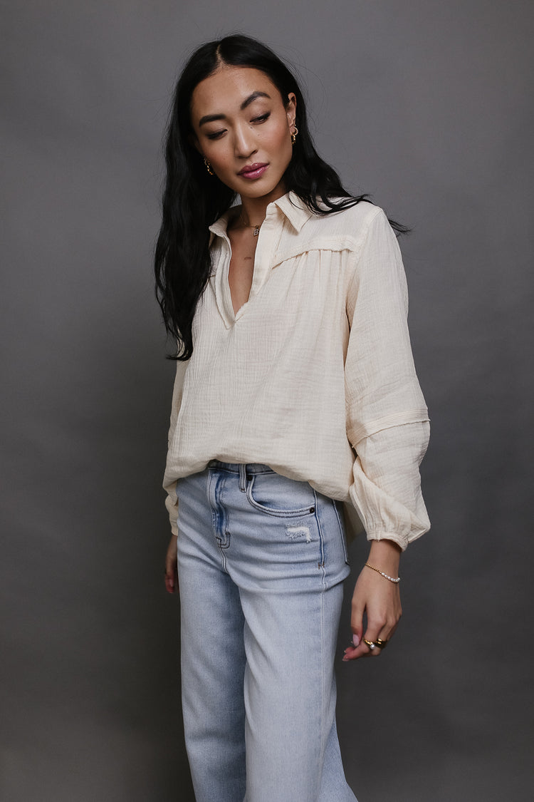 cream textured top with long sleeves