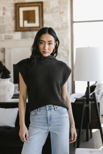 Shoulder pad sweater paired with denim jeans 