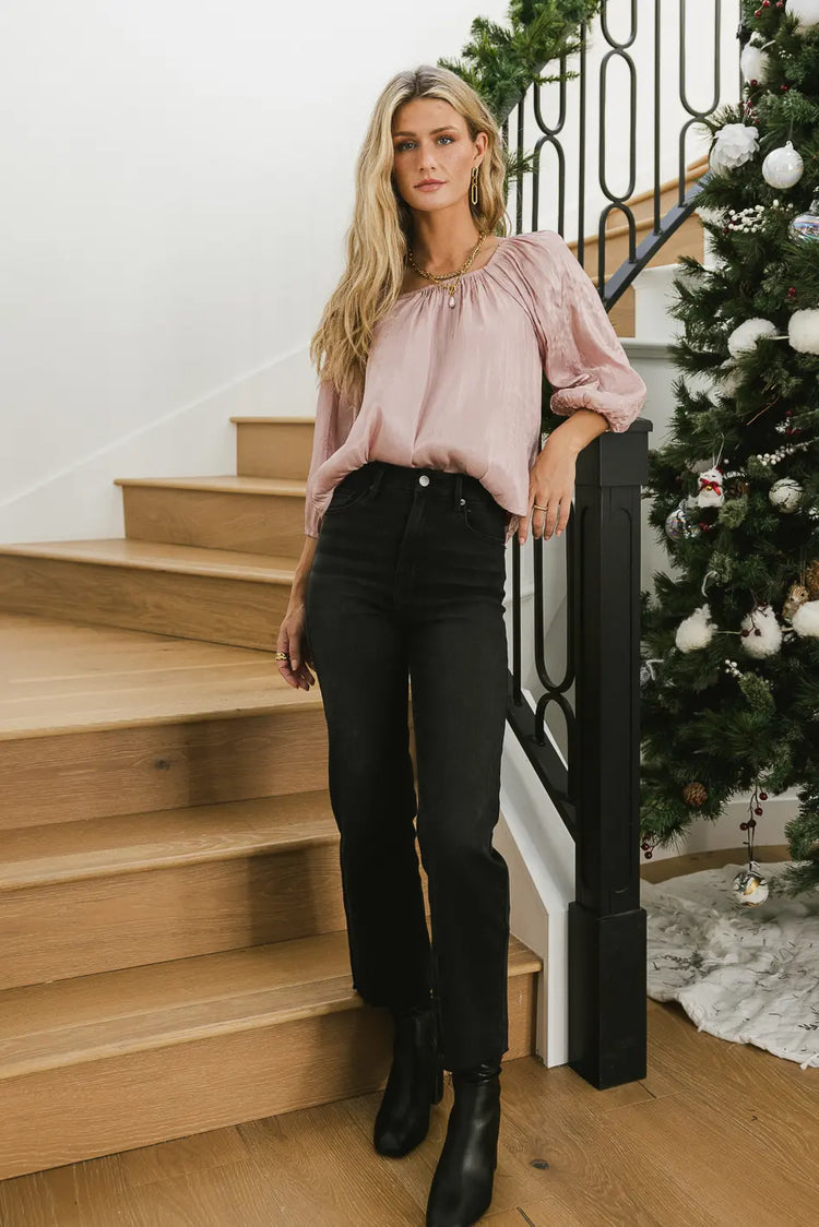 Pink blouse paired with black denim 