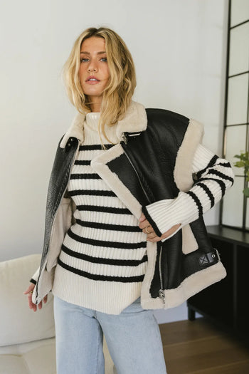 Striped sweater paired with a vest 