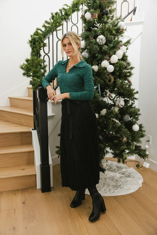 Top in green paired with a pleated skirt 