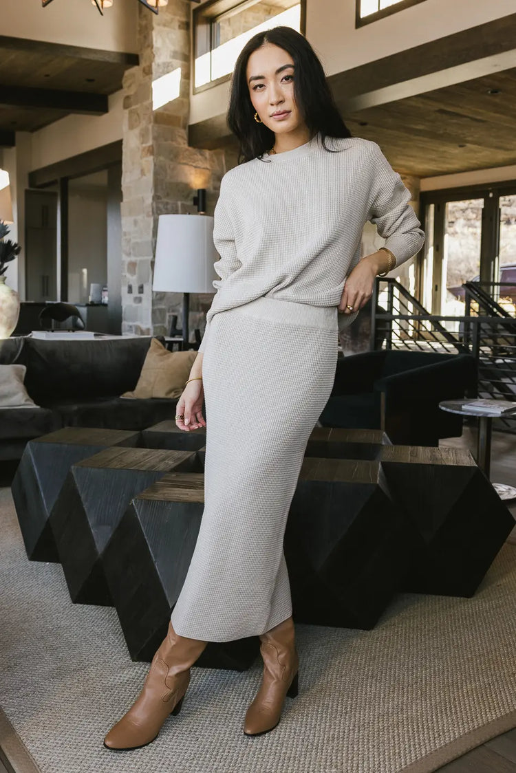 Midi skirt paired with a taupe sweater 