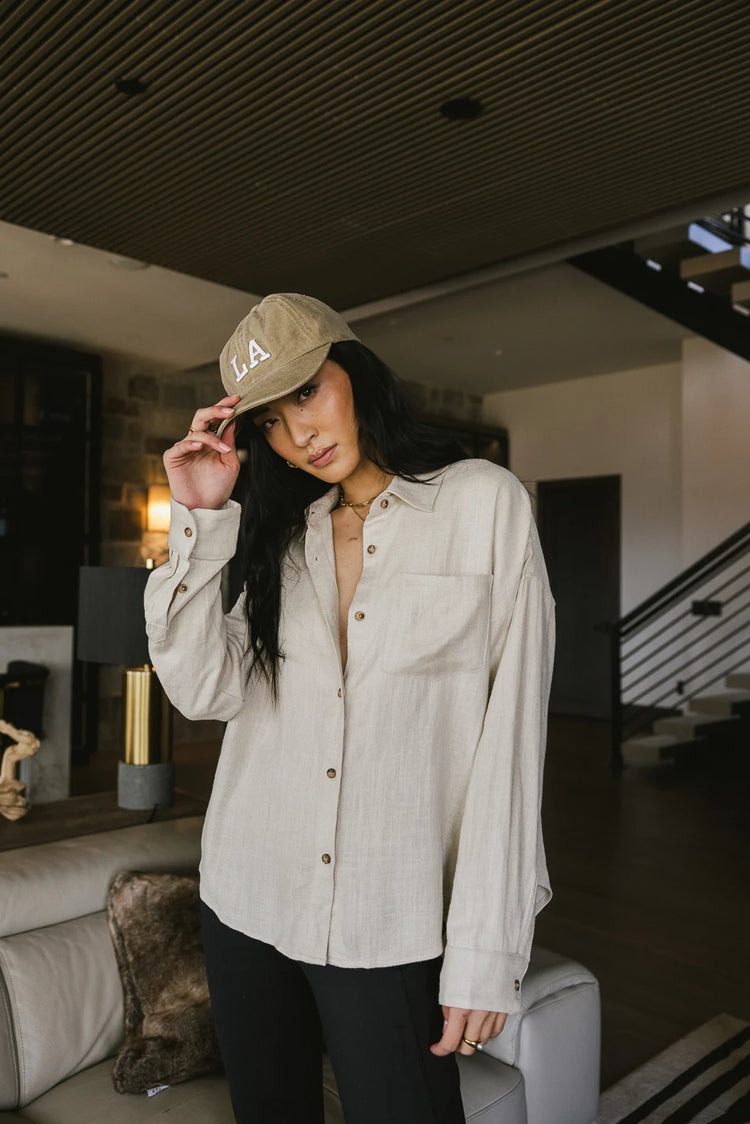 Button up paired with a hat 