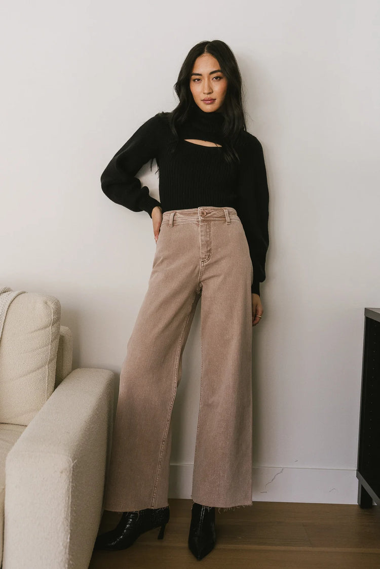Wide leg washed pants paired with a turtleneck sweater in black 
