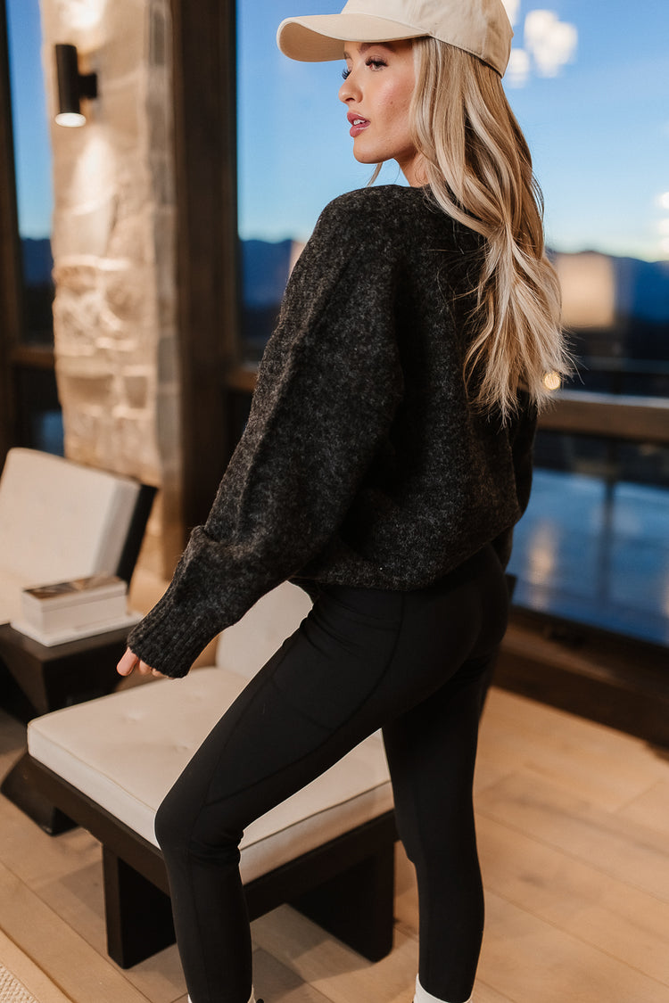 Sweater in black paired with black leggings 