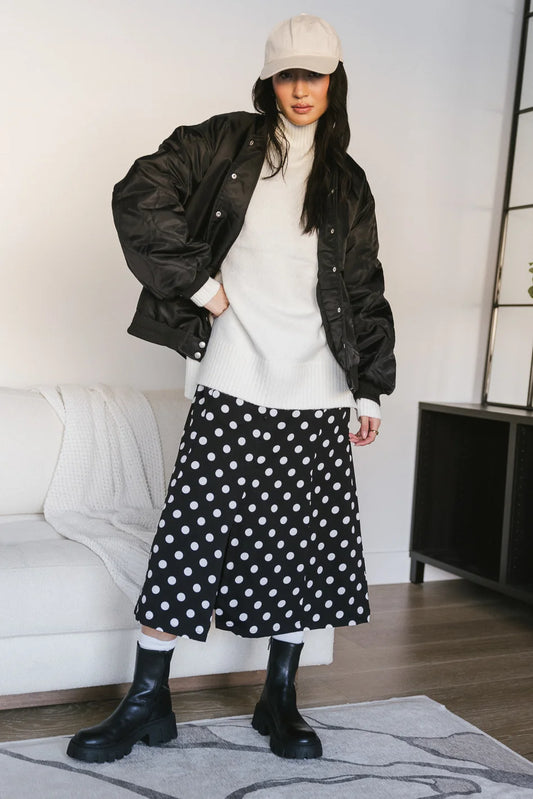 Bomber jacket paired with a polka dot dress 