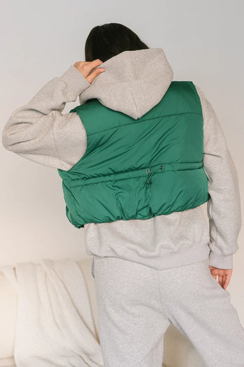 adjustable back on green puffer vest
