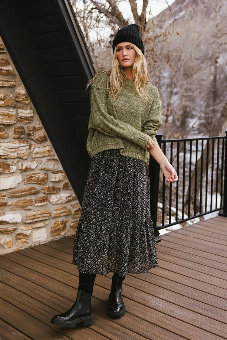 Sweater in olive paired with a dress