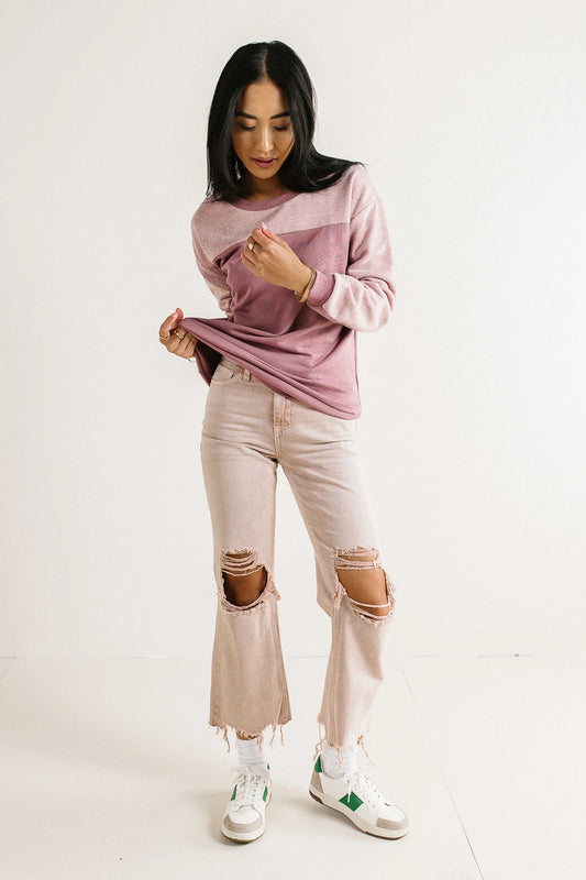 Colorblock sweatshirt paired with a distressed denim in mauve 