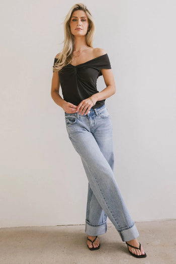 Top in black paired with a light wash denim 