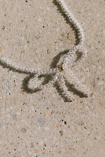 Beaded bow necklace in white 