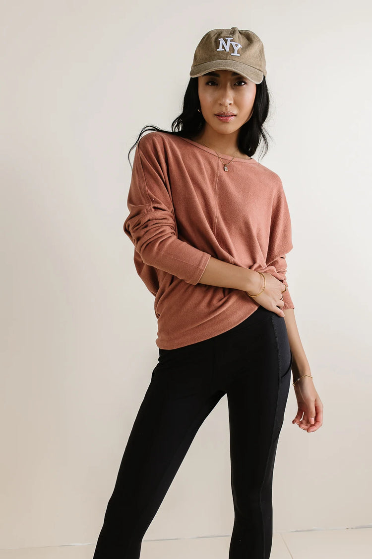 Sweater in rust paired with a black leggings 