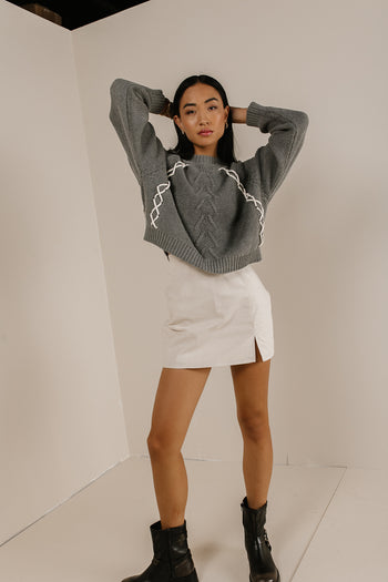grey knit sweater with white stitching