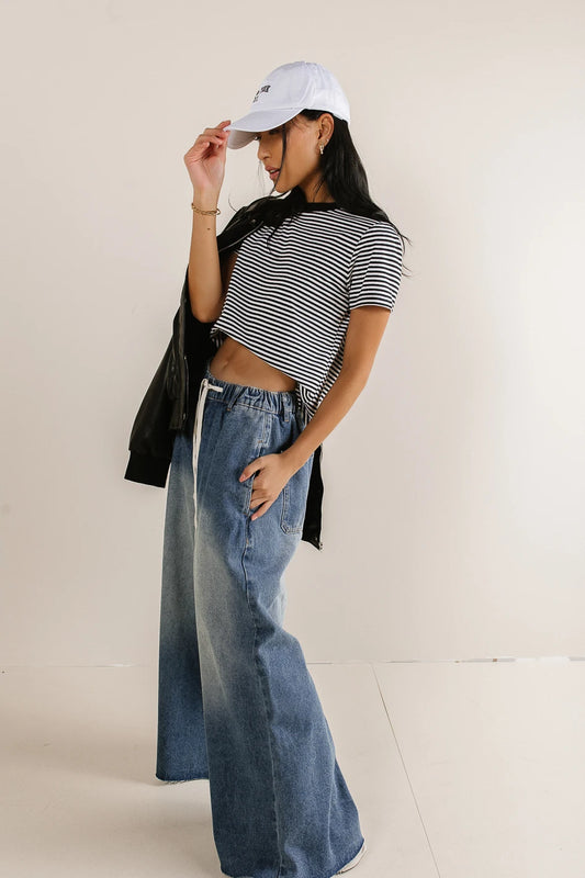 Top in black paired with a wide leg denim 