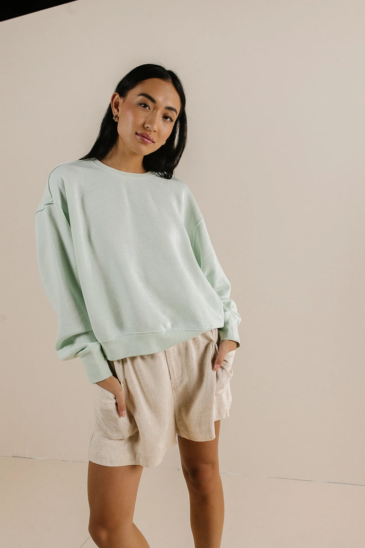 Sweatshirt in mint paired with a beige short 