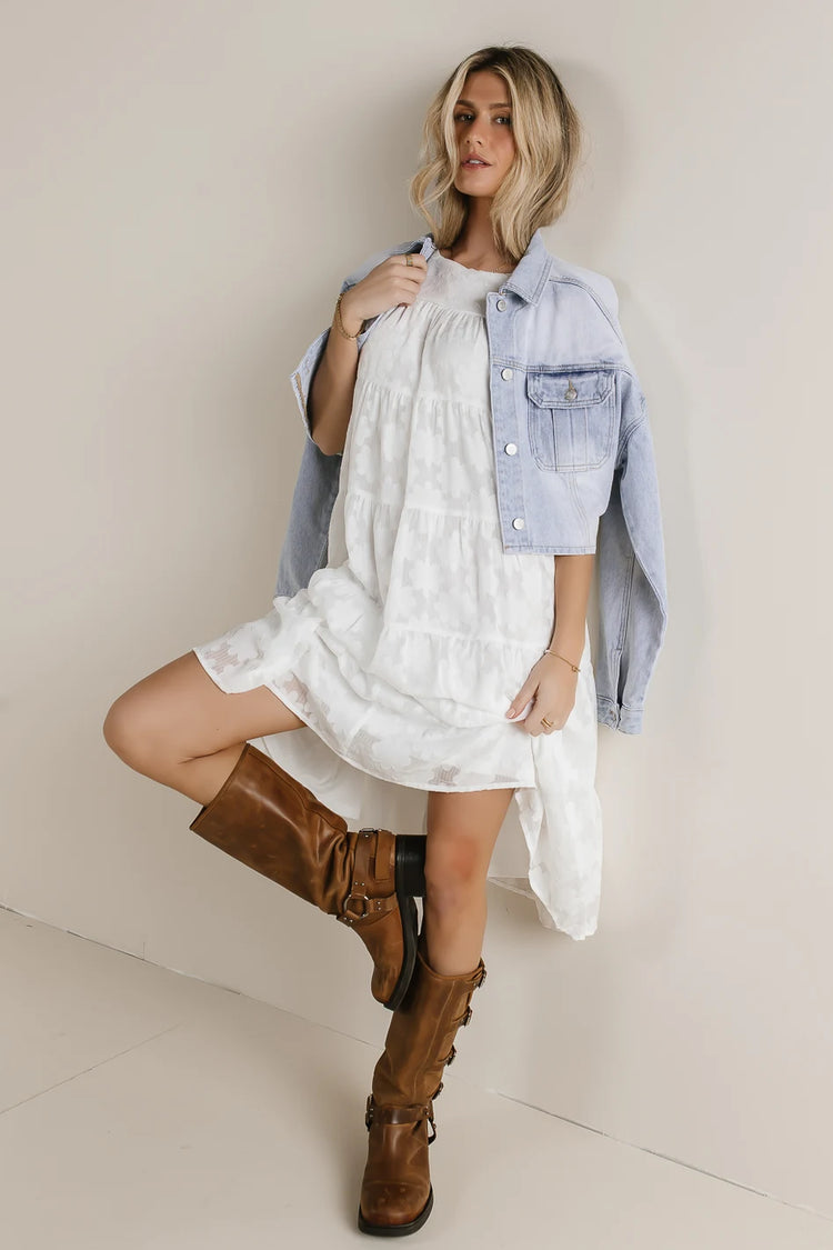 Dress in white with brown boots 