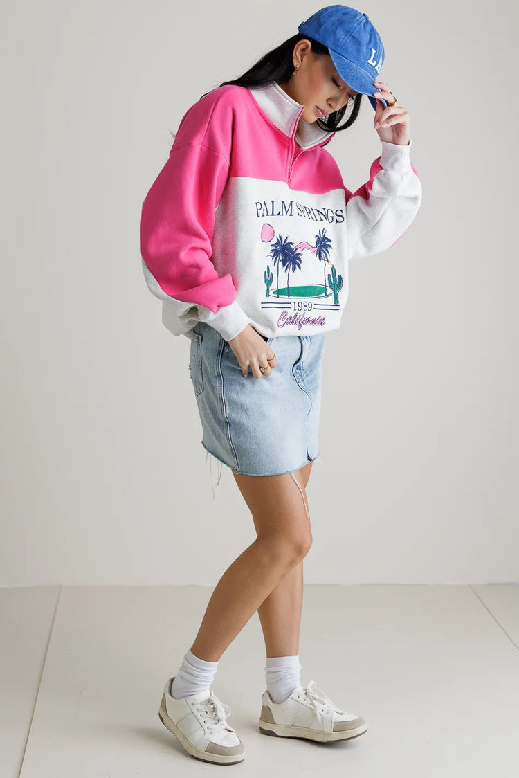 Sweater in pink paired with a denim skirt 