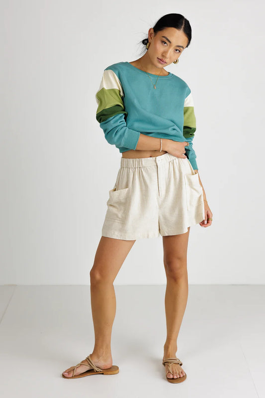 Sweater paired with a tan shorts 