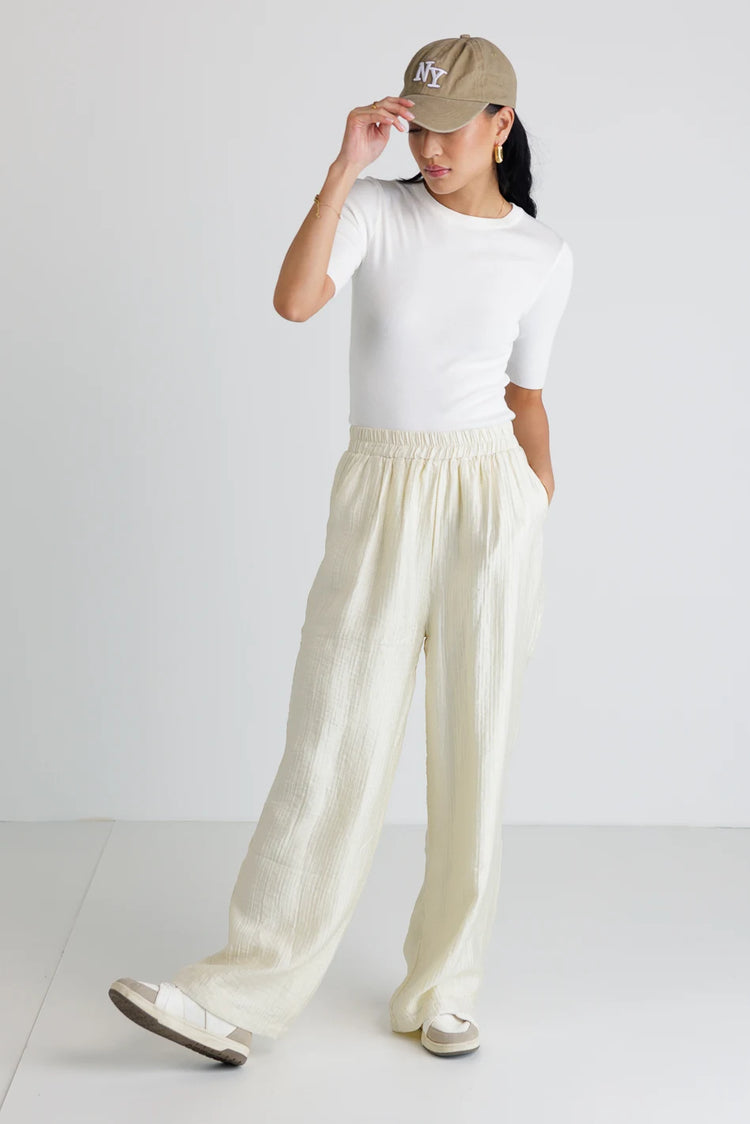 Top in white paired with a woven pants