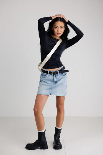 Top in black paired with a mini skirt 