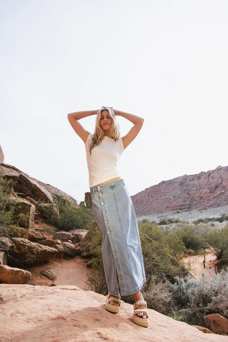 Light wash denim skirt paired with a white top 