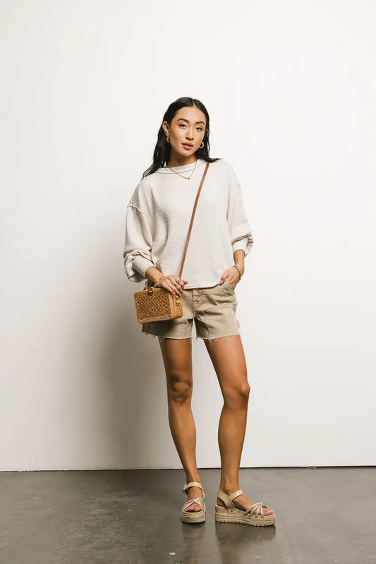 Top in cream paired with a denim short in camel  