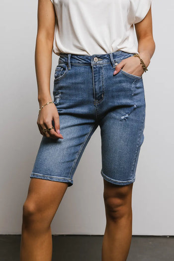 Distressed bermuda short in medium wash 