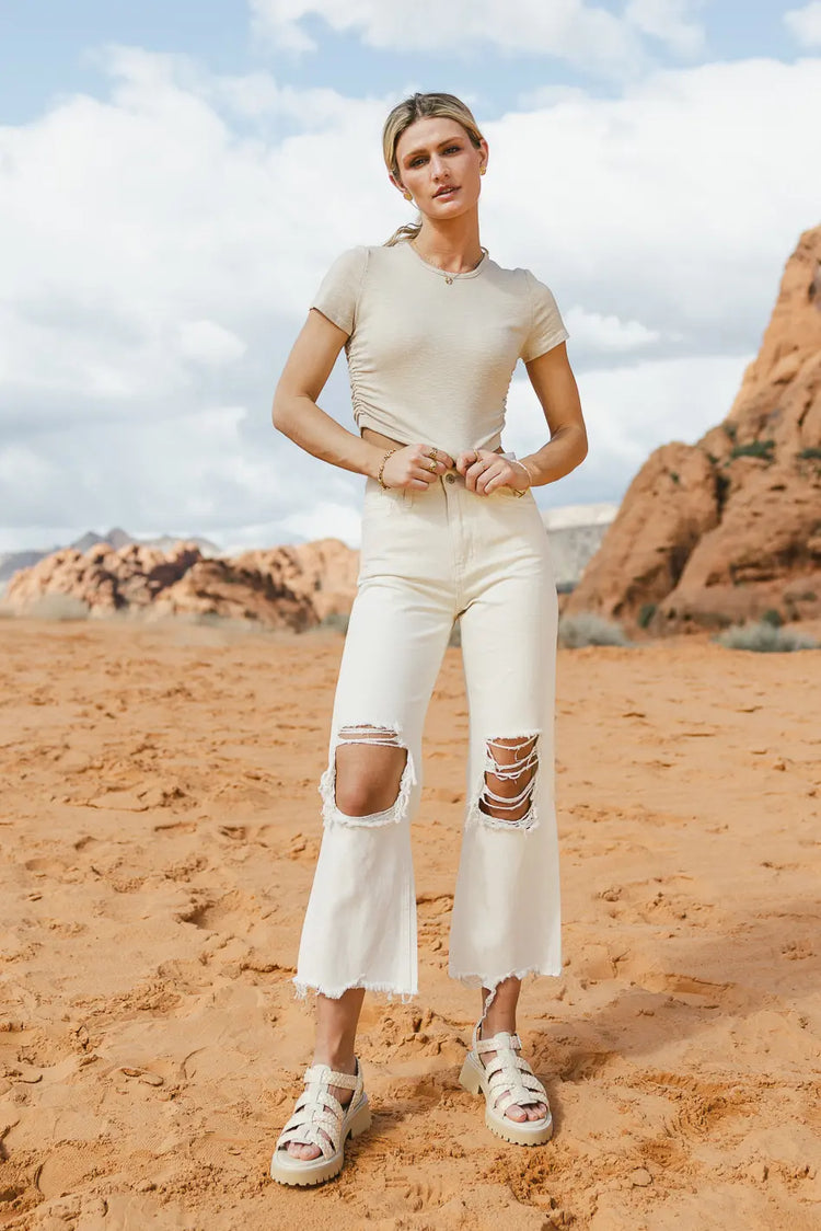 Cropped top in sand paired with a distressed denim 