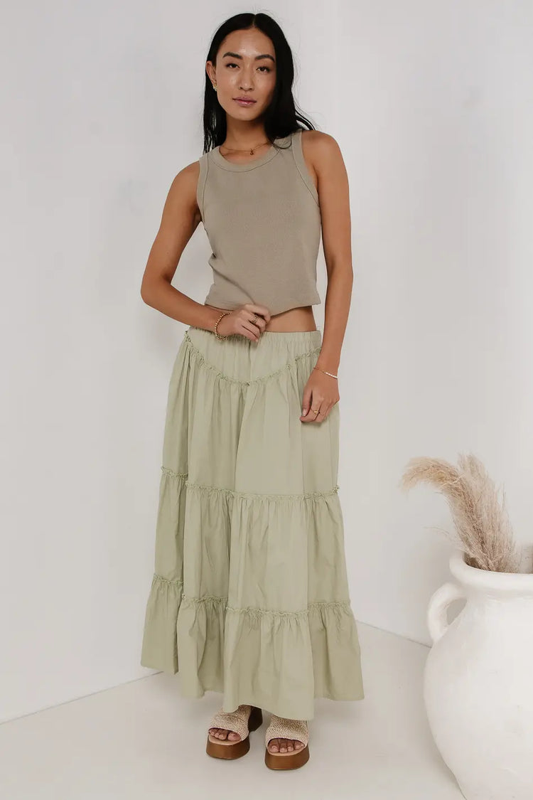 Tank top paired with a tiered skirt in sage 