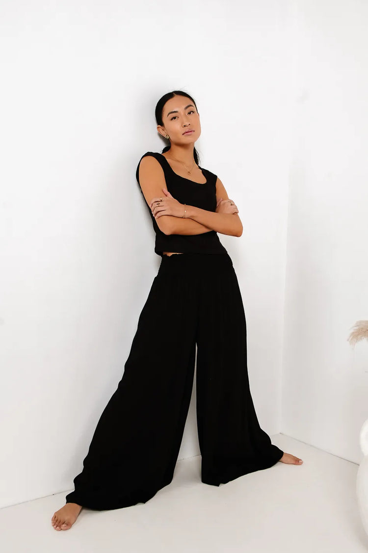 Wide leg pants in black paired with a black top 