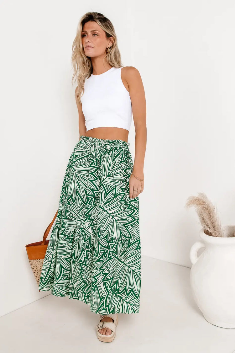 Printed skirt in green paired with a white tank 