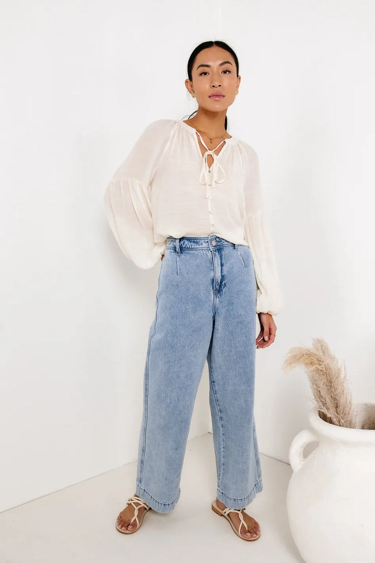 Cream top paired with a light denim pants 