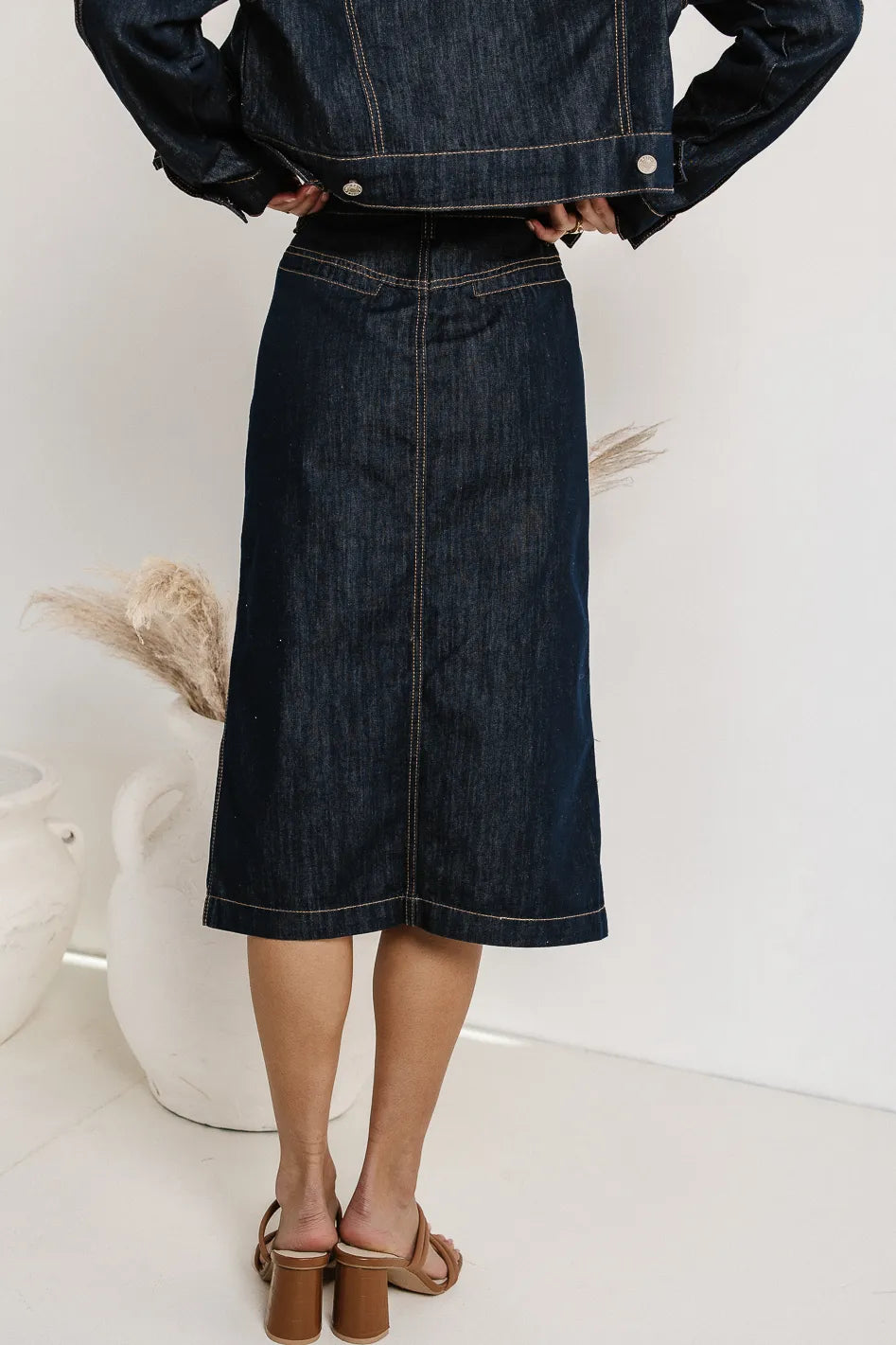 fake back pockets on denim skirt