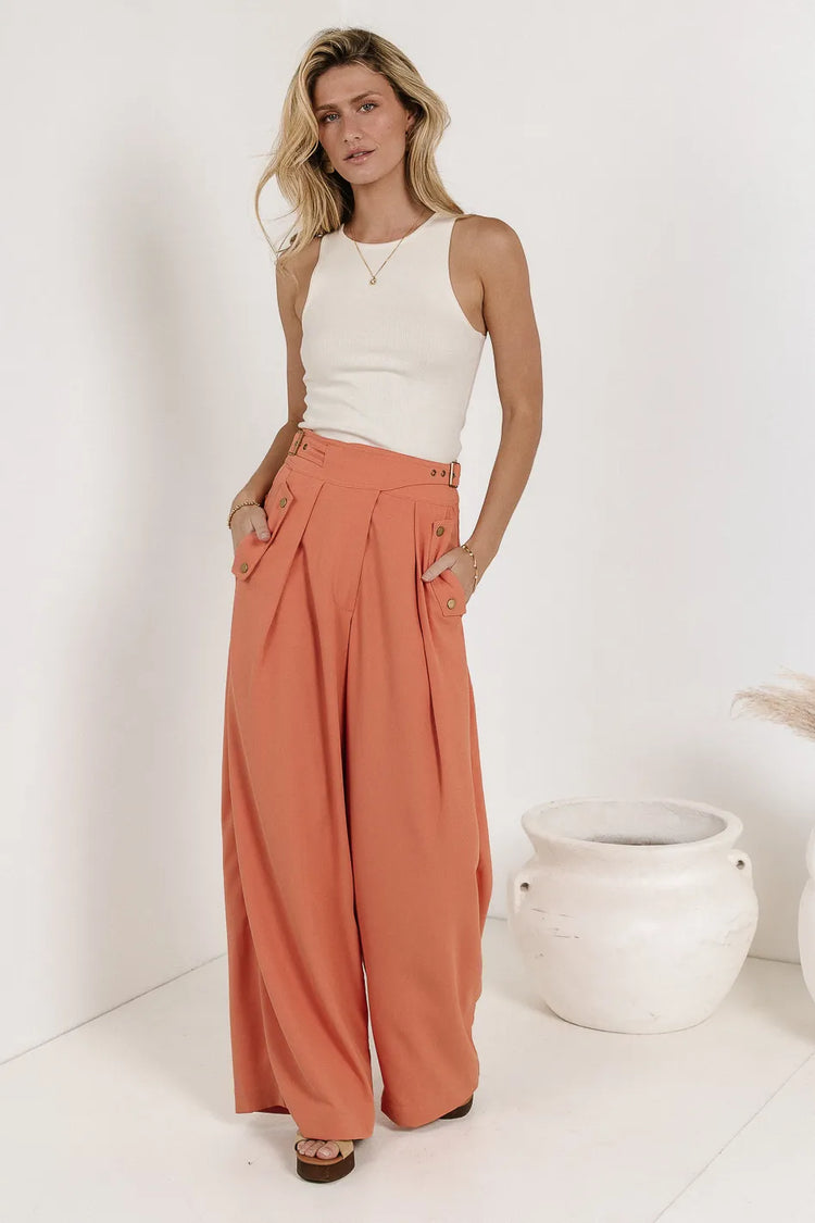 Basic top paired with a wide leg pant in orange 