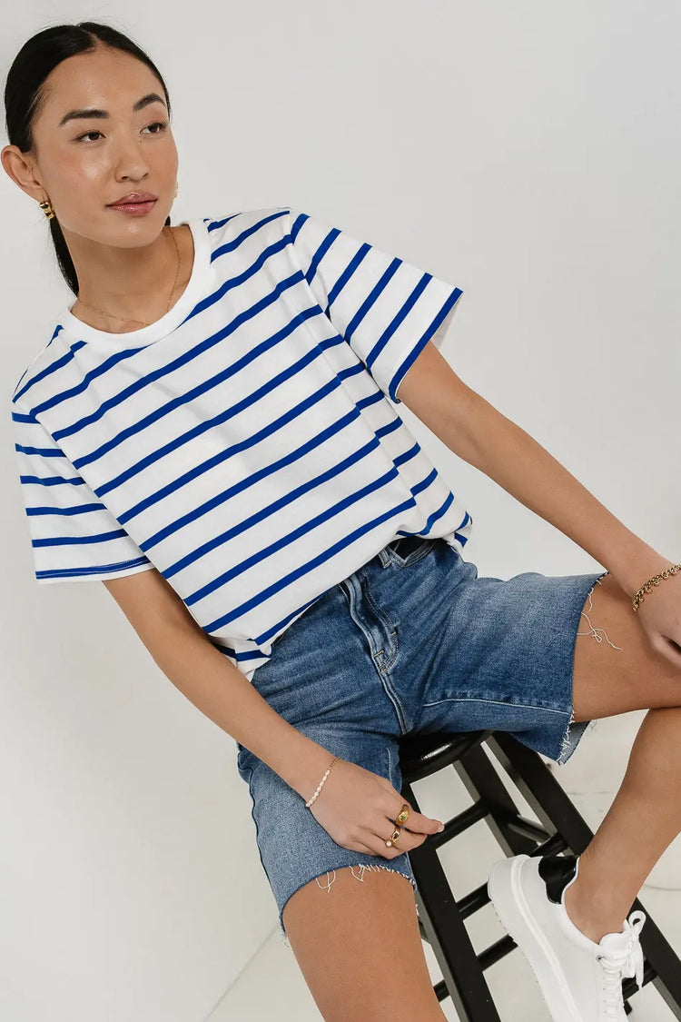 Denim bermuda paired with a striped top in blue 