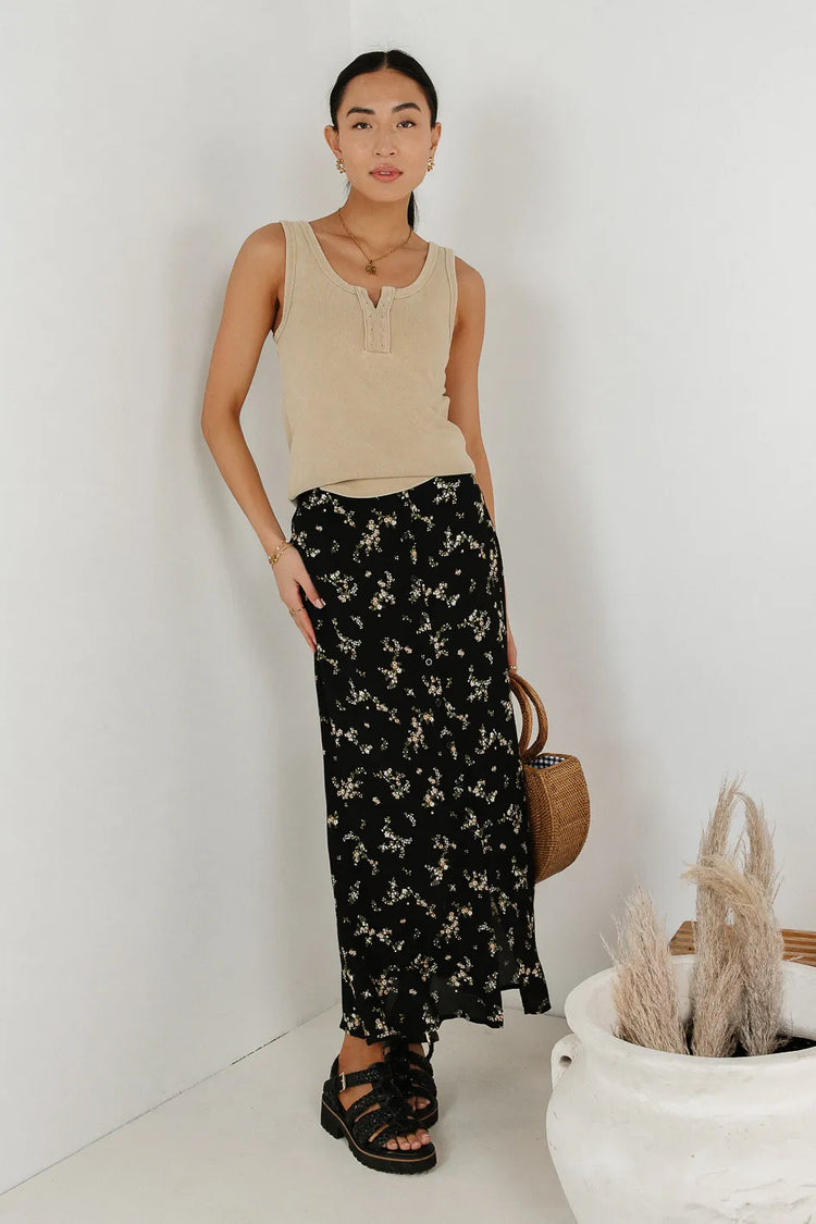 Top in beige paired with a floral skirt 