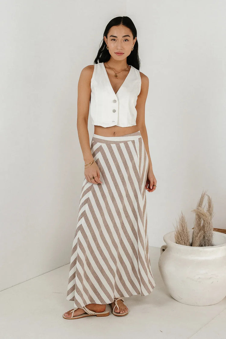 Maxi striped skirt paired with a cream denim vest 