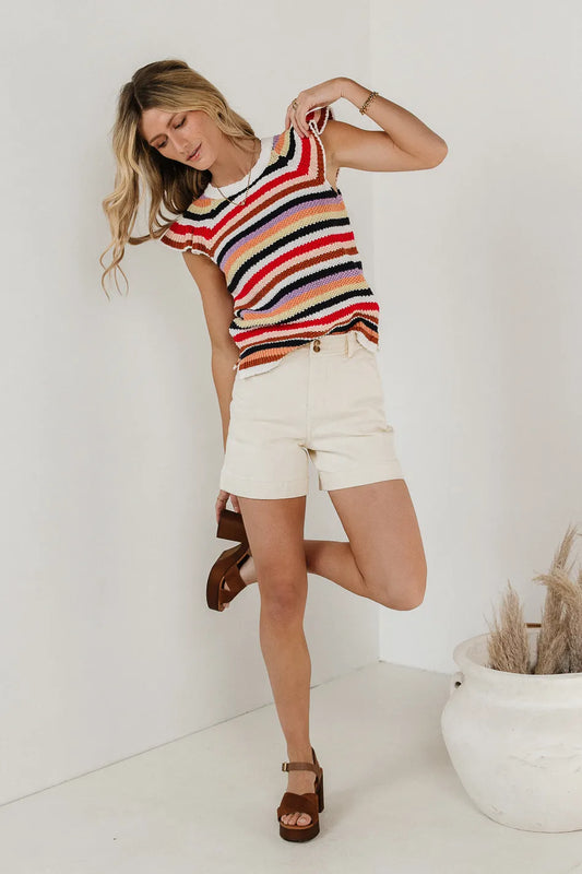 Striped top in multi color paired with cream shorts 